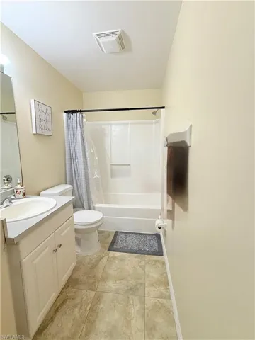 Full bathroom with vanity and shower / bathtub combination with curtain