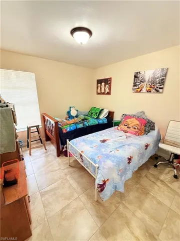 Bedroom with light tile patterned floors