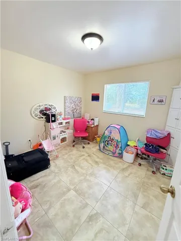 Game room featuring light tile patterned floors