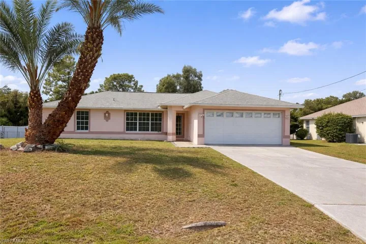 Single story home featuring stucco siding, concrete driveway, and a garage