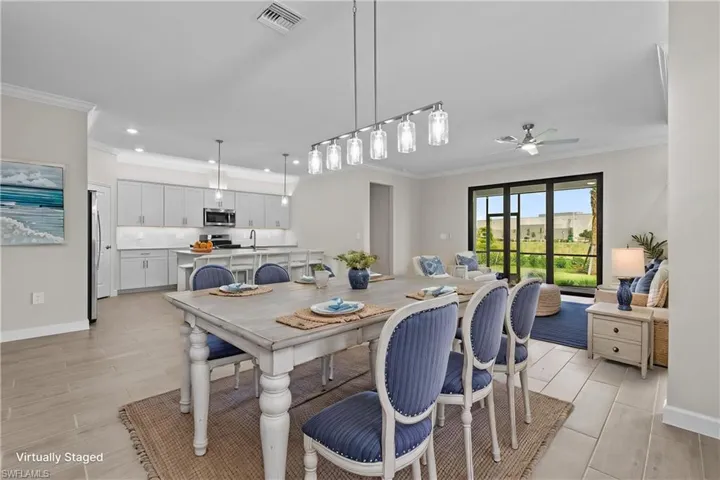 Dining space with crown molding, recessed lighting, a ceiling fan, baseboards, and light wood-type flooring