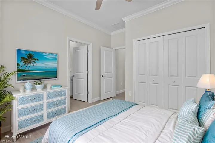 Bedroom featuring ornamental molding, a closet, baseboards, and ceiling fan