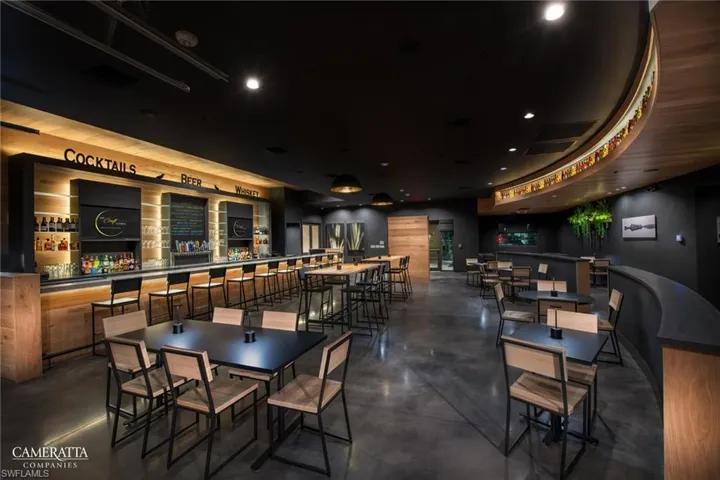 Dining room featuring concrete floors, recessed lighting, and a community bar