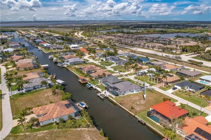 View of property location with a nearby body of water and nearby suburban area