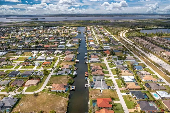 View of property location with a nearby body of water and nearby suburban area