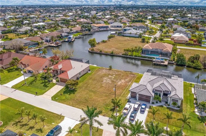 Aerial view of residential area featuring a large body of water