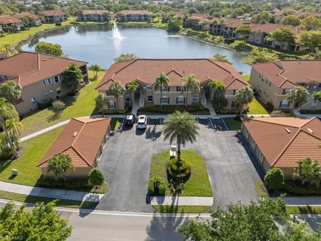 Birds eye view of property with a water view and a residential view