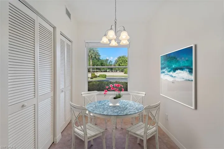 Tiled dining area featuring an inviting chandelier, baseboards, and visible vents