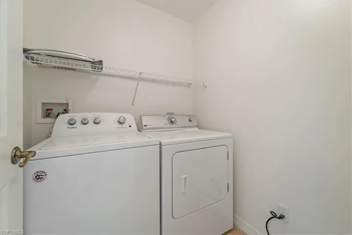 Laundry room featuring baseboards, washer and dryer, and laundry area
