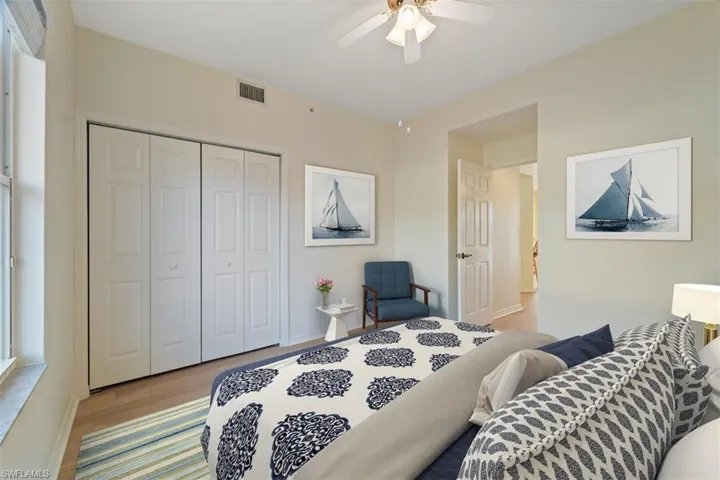 Bedroom with visible vents, a closet, baseboards, ceiling fan, and light wood-style floors