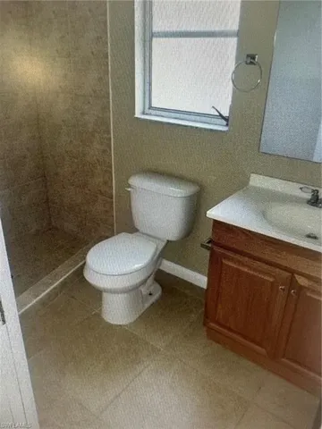 Bathroom with vanity and a tile shower