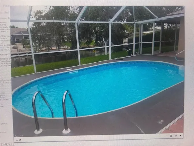Swimming pool featuring glass enclosure and a sunroom