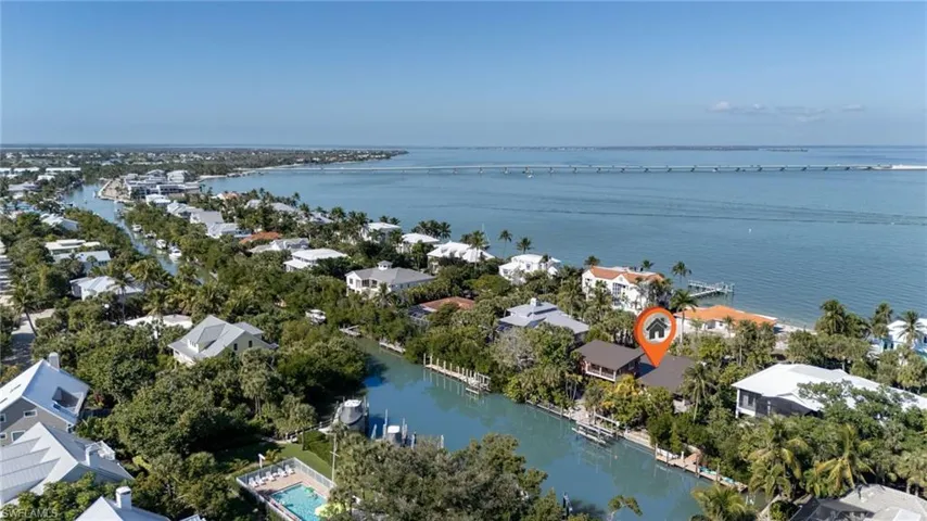 Aerial view of residential area featuring a nearby body of water
