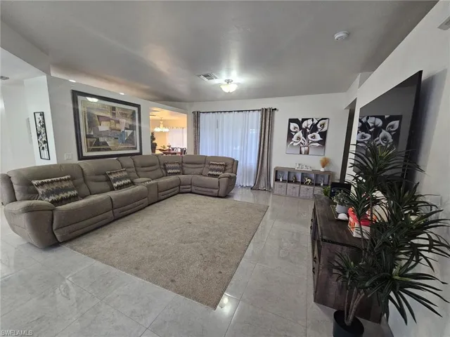 Living room with light tile patterned flooring