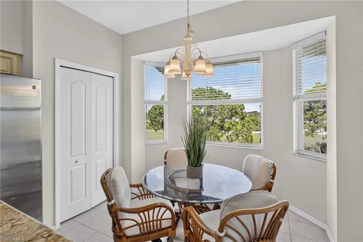 Bright dining area with a bay window, offering natural light and exterior views