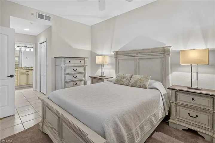 Bedroom with light-toned walls and ceiling fan