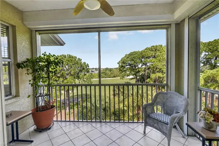 Screened lanai featuring tiled flooring and a ceiling fan