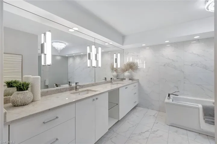 4651 Gulf Shore Blvd 806 - Primary Bath with custom cabinetry and Jacuzzi Tub