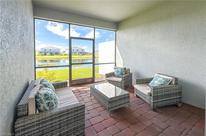 Sunroom with a water view and outdoor lounge area