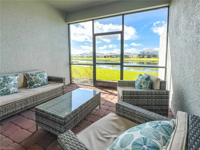 Sunroom featuring an outdoor hangout area, a water view, and a residential view