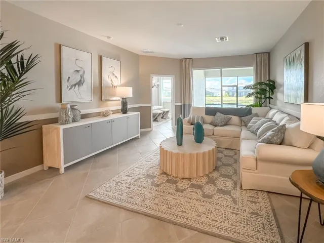 Living area featuring light tile patterned floors and baseboards