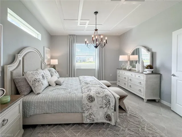 Bedroom featuring light tile patterned floors and a chandelier