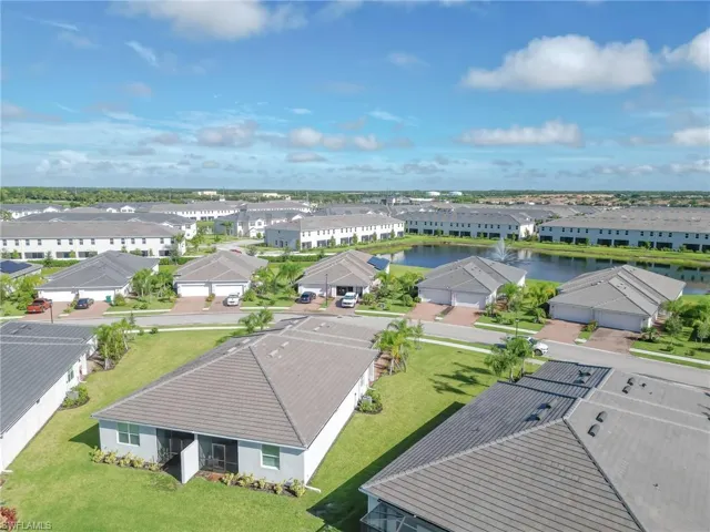 Aerial view of residential area featuring a large body of water