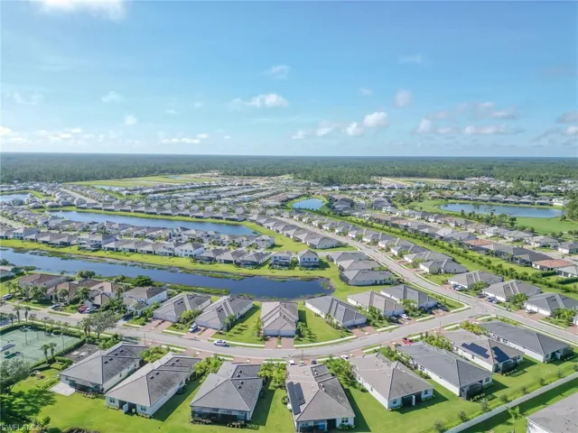 Aerial perspective of suburban area featuring a nearby body of water