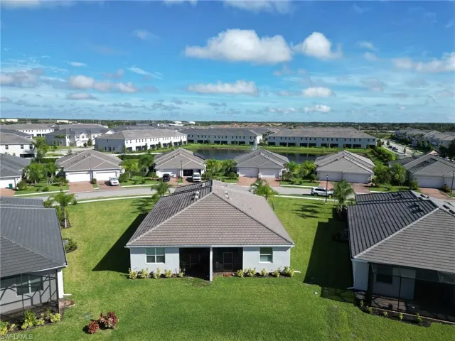 Aerial perspective of suburban area with a nearby body of water