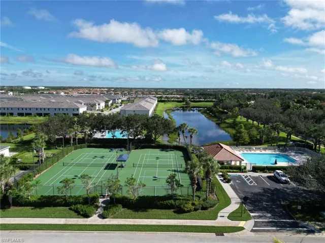 Drone / aerial view of a pool and a large body of water