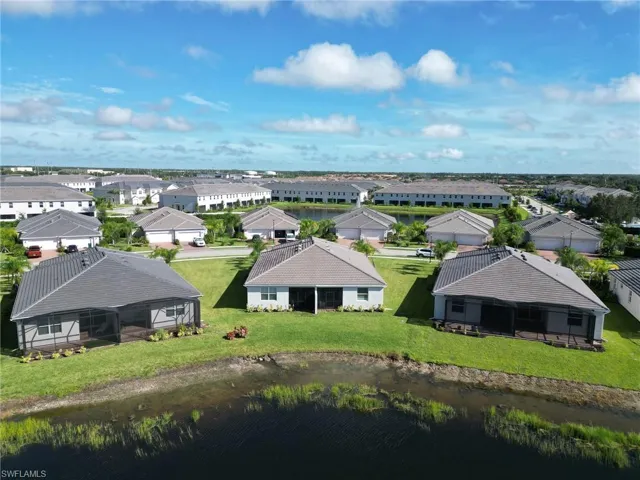 Aerial view of residential area featuring a large body of water