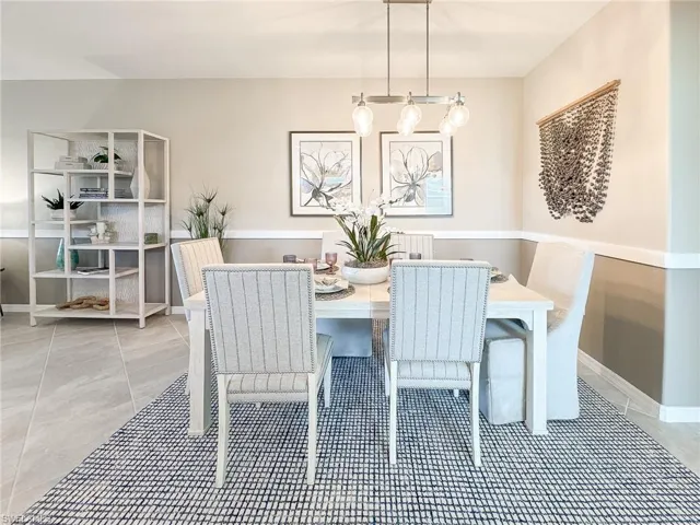 Dining room featuring light tile patterned floors and baseboards