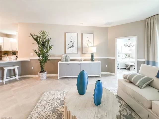 Living area featuring a chandelier and light tile patterned floors