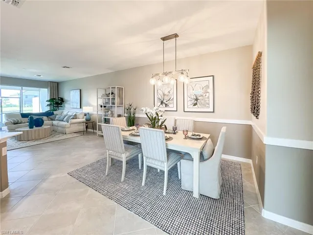 Dining room featuring light tile patterned floors and a chandelier