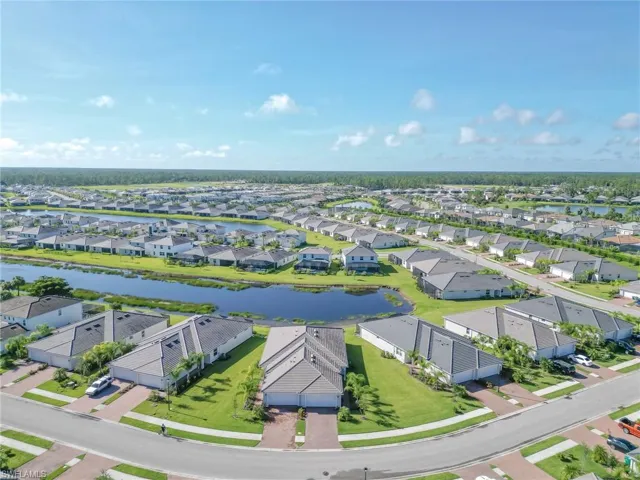 Aerial perspective of suburban area featuring a large body of water