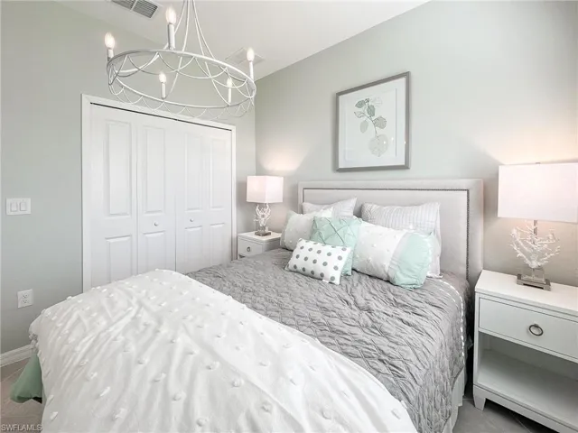 Bedroom with a chandelier and a closet