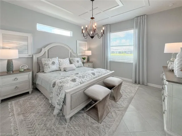 Bedroom with light tile patterned floors and a chandelier