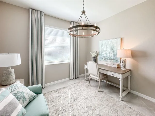 Office space featuring a chandelier and light tile patterned flooring