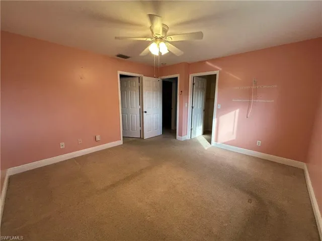 Unfurnished bedroom featuring a ceiling fan and carpet flooring