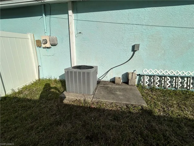 Exterior view of stucco siding and a central air condition unit