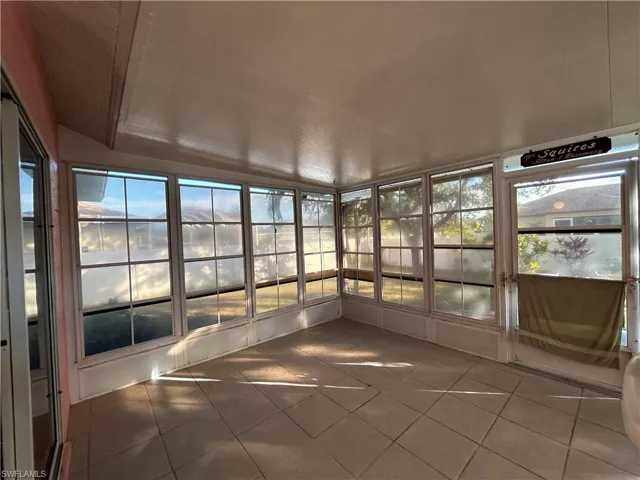 Unfurnished sunroom featuring tile patterned flooring