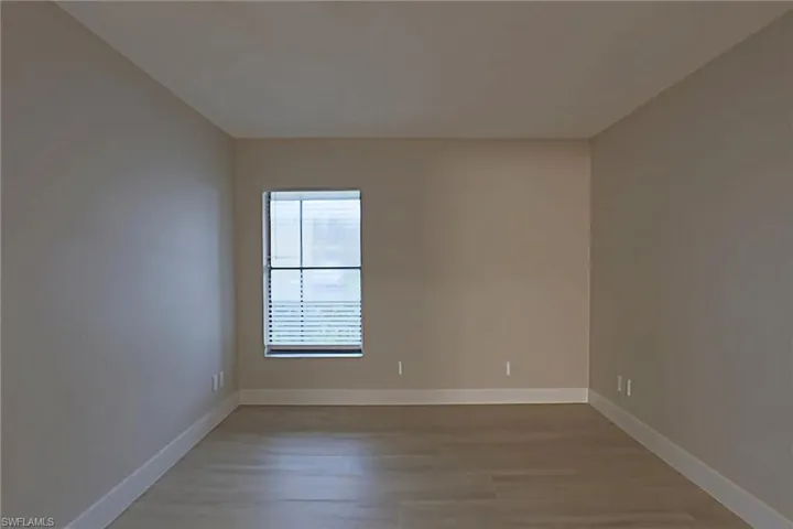 Unfurnished room featuring baseboards and light wood finished floors