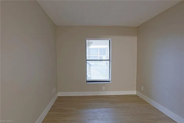Spare room featuring light wood-style flooring and a textured ceiling