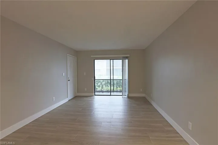 Unfurnished room featuring baseboards and light wood finished floors