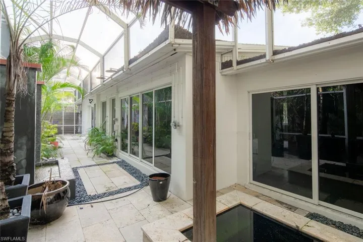 View of patio featuring a lanai