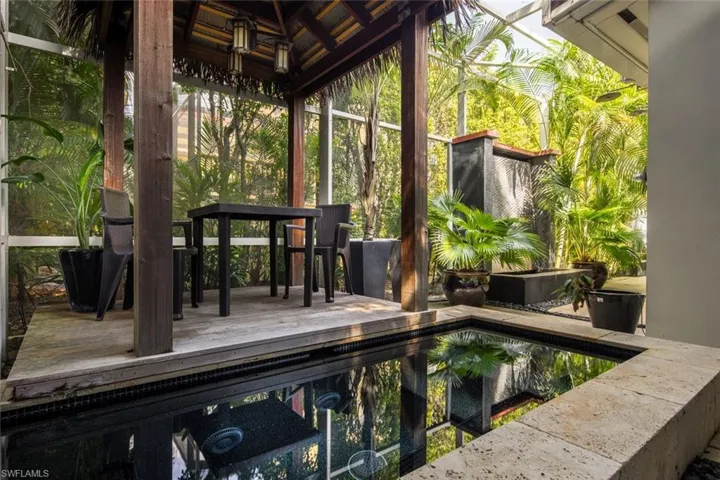 Deck featuring a gazebo and exterior bar