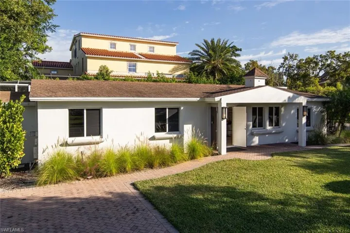 Rear view of property featuring a lawn