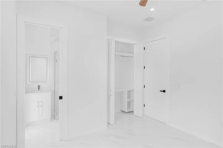Corridor with recessed lighting, marble finish floor, visible vents, and baseboards