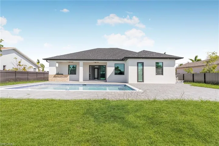 Back of house featuring a patio, fence, a ceiling fan, and a yard