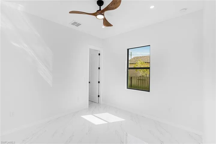 Unfurnished room featuring baseboards, visible vents, a ceiling fan, marble finish floor, and recessed lighting